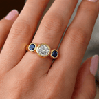 Bezel Set Three-Stone Round & Oval Cut White & Blue Sapphire Engagement Ring