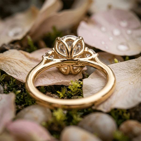 Classic Three Stone Oval Cut White Sapphire Engagement Ring In Yellow Gold