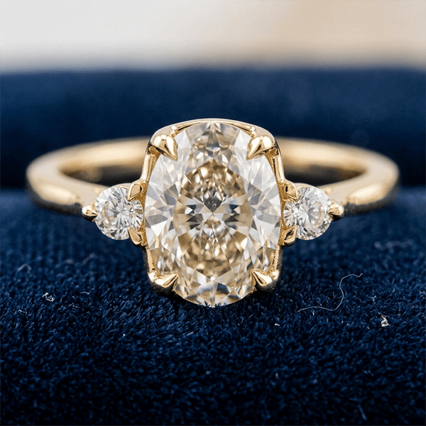 Classic Three Stone Oval Cut White Sapphire Engagement Ring In Yellow Gold