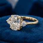Classic Three Stone Oval Cut White Sapphire Engagement Ring In Yellow Gold