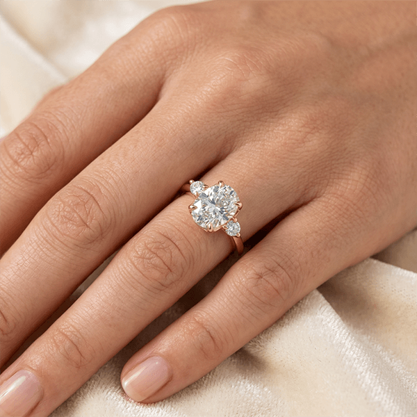 Classic Three Stone Oval Cut White Sapphire Engagement Ring In Yellow Gold