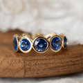 Classic Bezel Eternity Yellow Gold Round Cut Blue Sapphire Wedding Band For Women