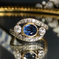 Two Tone Bezel Three Stone Oval Cut Blue Sapphire Engagement Ring